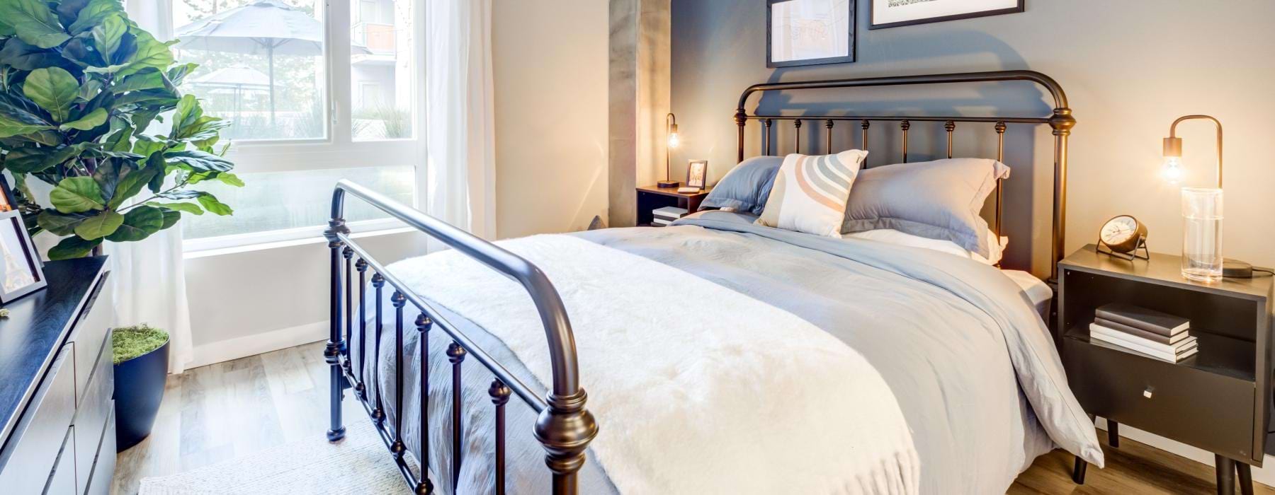 a bedroom with a bed and a window