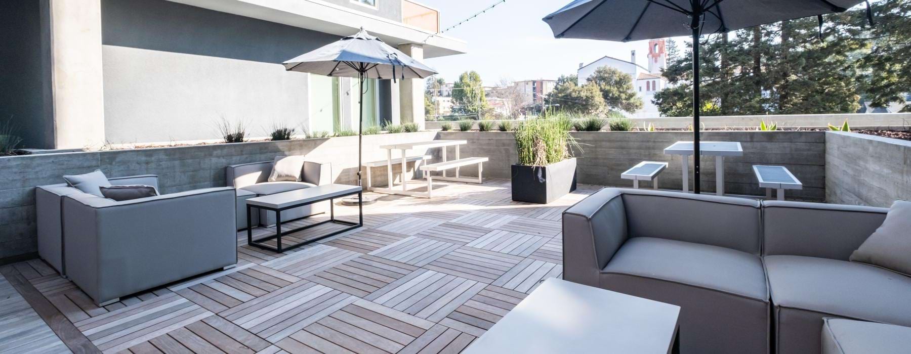 rooftop patio with outdoor furniture and umbrella