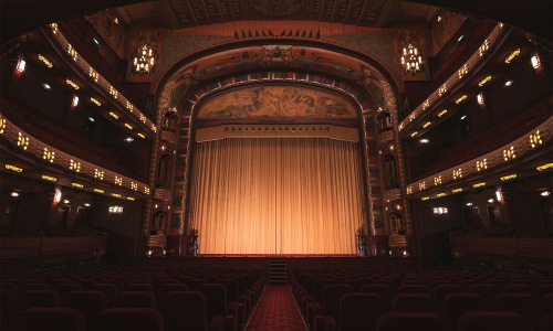 a theater with a stage and chairs