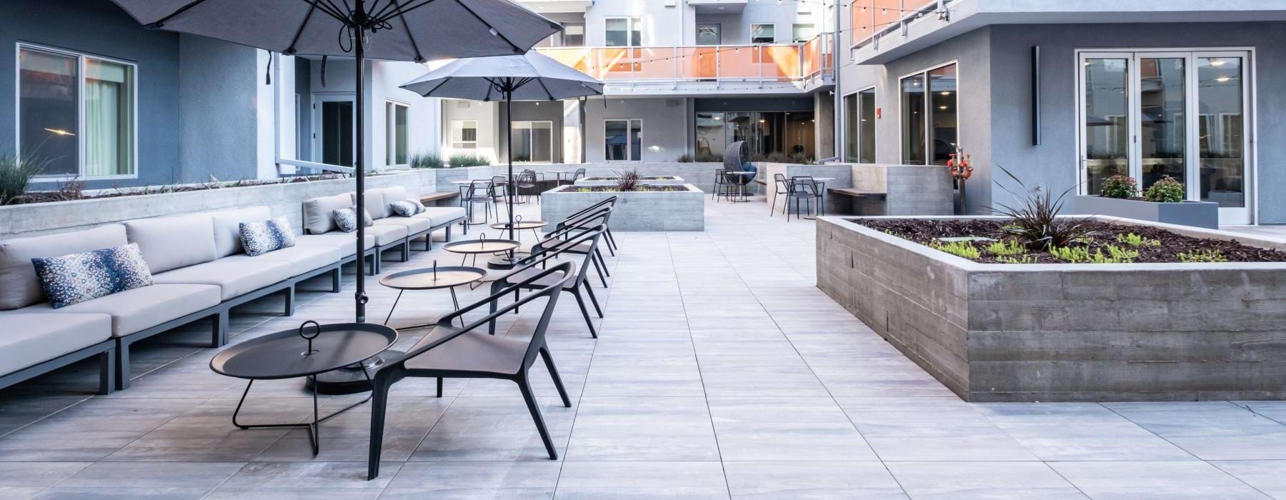 patio with umbrella shaded tables and chairs